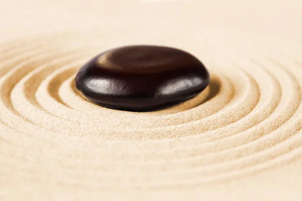 Black stone in the sand. Zen japanese garden background scene