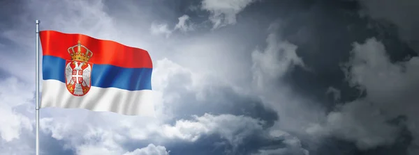 塞尔维亚国旗挂在多云的天空上 三维渲染 — 图库照片