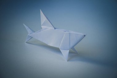 Paper shark origami isolated on a blank background