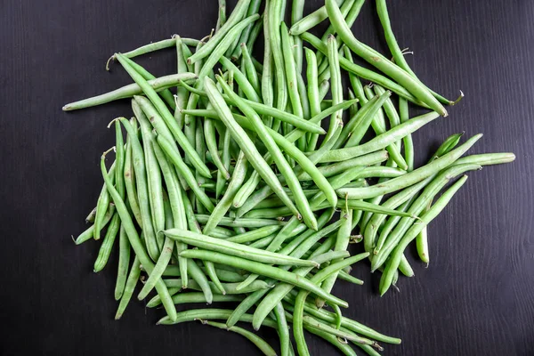 Fresh green beans isolated on black background