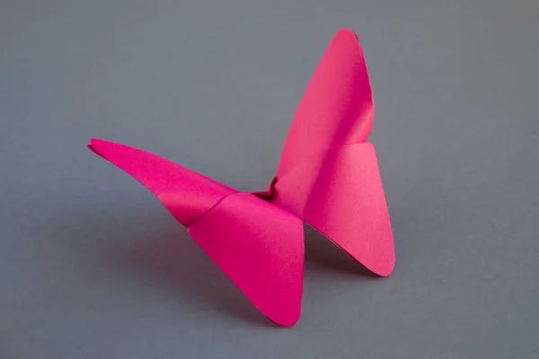 Roze Papier Vlinder Origami Geïsoleerd Een Lege Grijze Achtergrond — Stockfoto