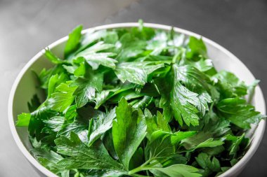 Fresh parsley leaves in a white bowl