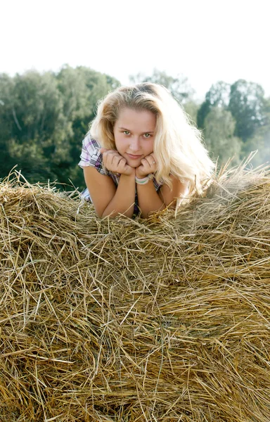 Girl sitting on hay — Stock Photo, Image