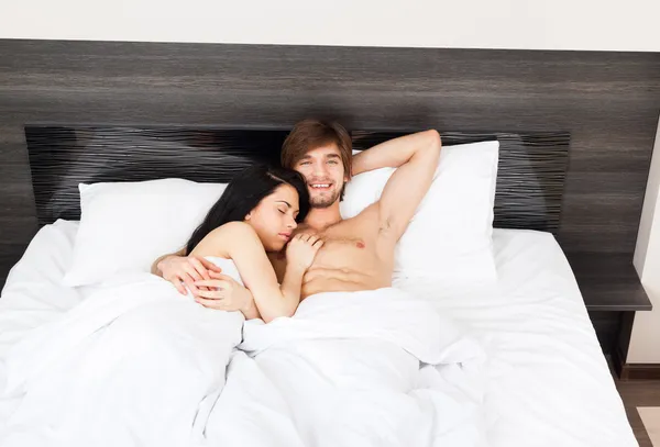 Pareja joven en la cama — Foto de Stock