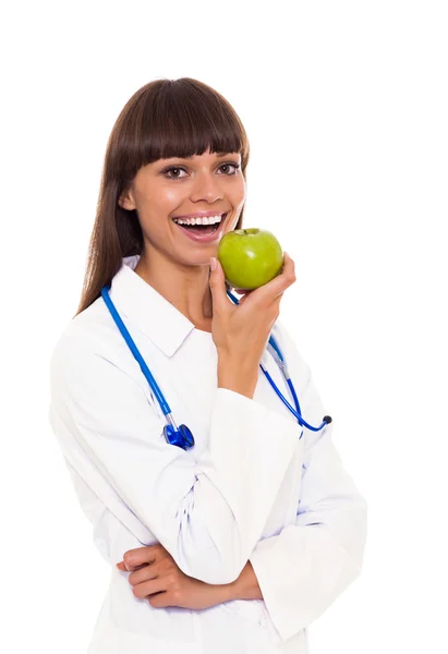 Female doctor eating an apple — Stock Photo, Image