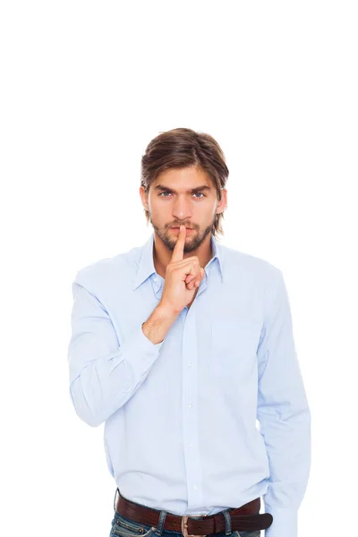 Hombre de negocios con el dedo en los labios sonrisa —  Fotos de Stock