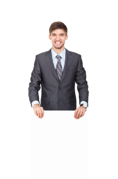 Podnikatel drží prázdné bílé lepenku — Stock fotografie