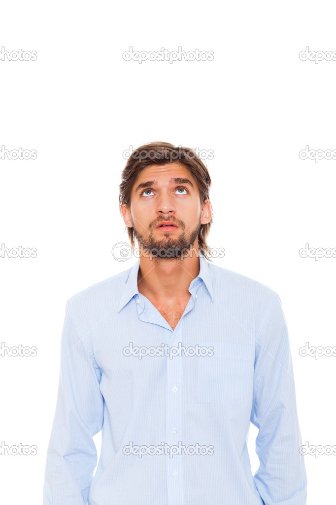 Young man looking up to empty copy space