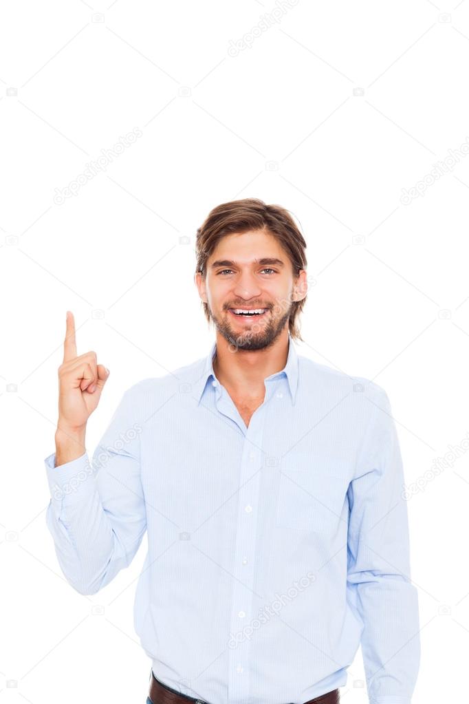 Handsome young business man happy smile point finger to empty copy space
