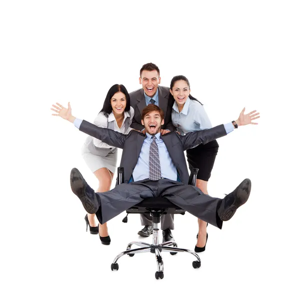 Excited Business people push colleague sitting in chair — Stock Photo, Image