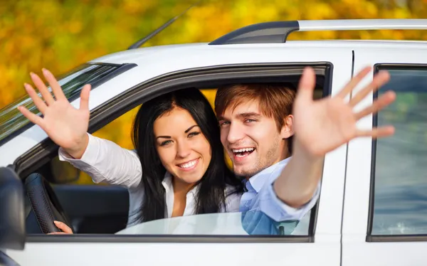 Jovem casal feliz dirigindo no carro — Fotografia de Stock