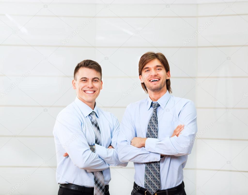 Smiling businessmen with folded hands