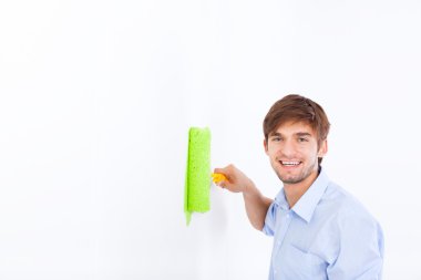 Man paint in green color white wall