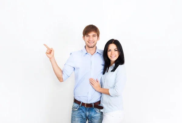 Couple smile at white wall with copy space — Stock Photo, Image