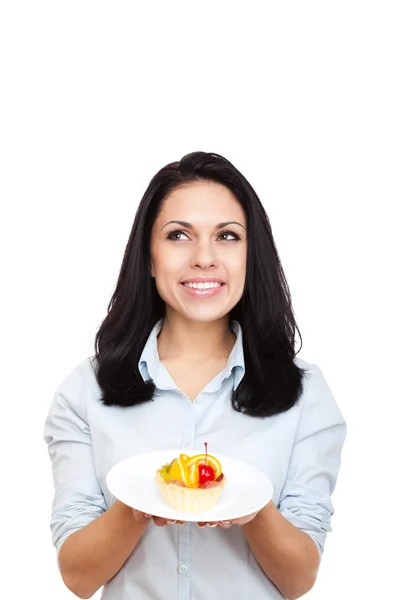 Joven mujer sosteniendo pedazo de pastel — Foto de Stock