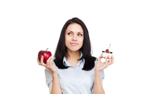 Woman hold piece of cake and red apple — Stock Photo, Image