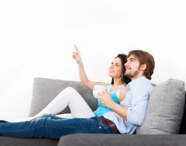 Couple sitting on couch drink coffee — Stock Photo, Image