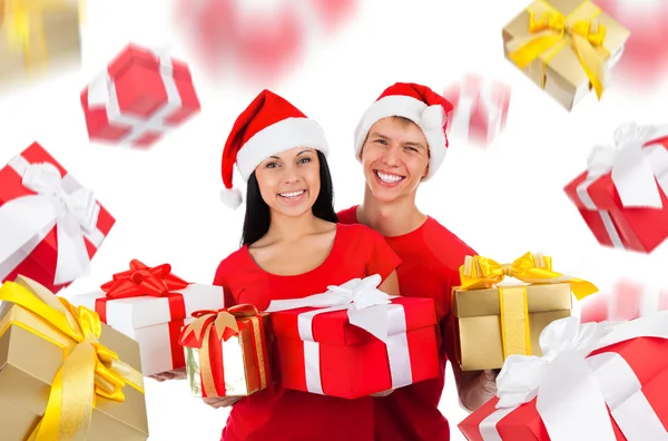 Excited couple wear red Christmas hats — Stock Photo, Image