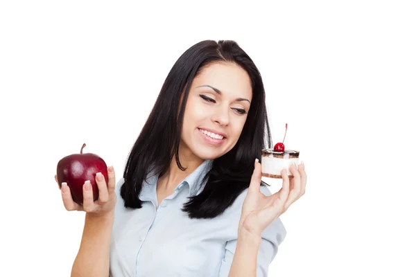 Young woman hold delicious piece of cake on plate and green apple — Stock Photo, Image