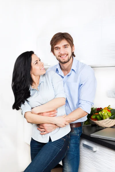 Happy couple cooking at their kitchen — Stock Photo, Image