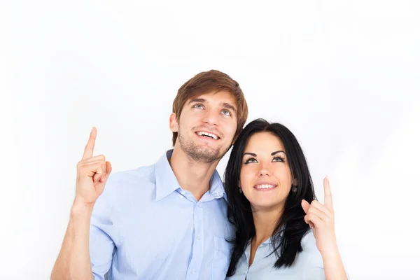 Paar lächelt erhobenen Zeigefinger — Stockfoto