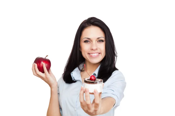 Woman hold piece of cake and apple — Stock Photo, Image