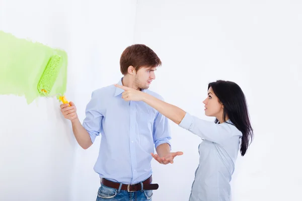 Conflict couple, paint in green color white wall — Stock Photo, Image