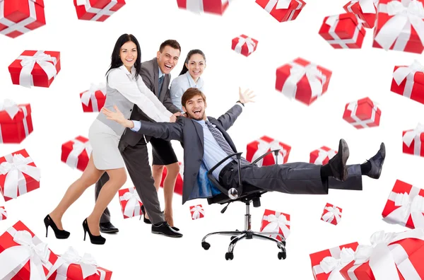 Business people group team push man leader colleague sitting in chair Royalty Free Stock Photos