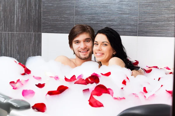 Young happy couple lying in jacuzzi Royalty Free Stock Images