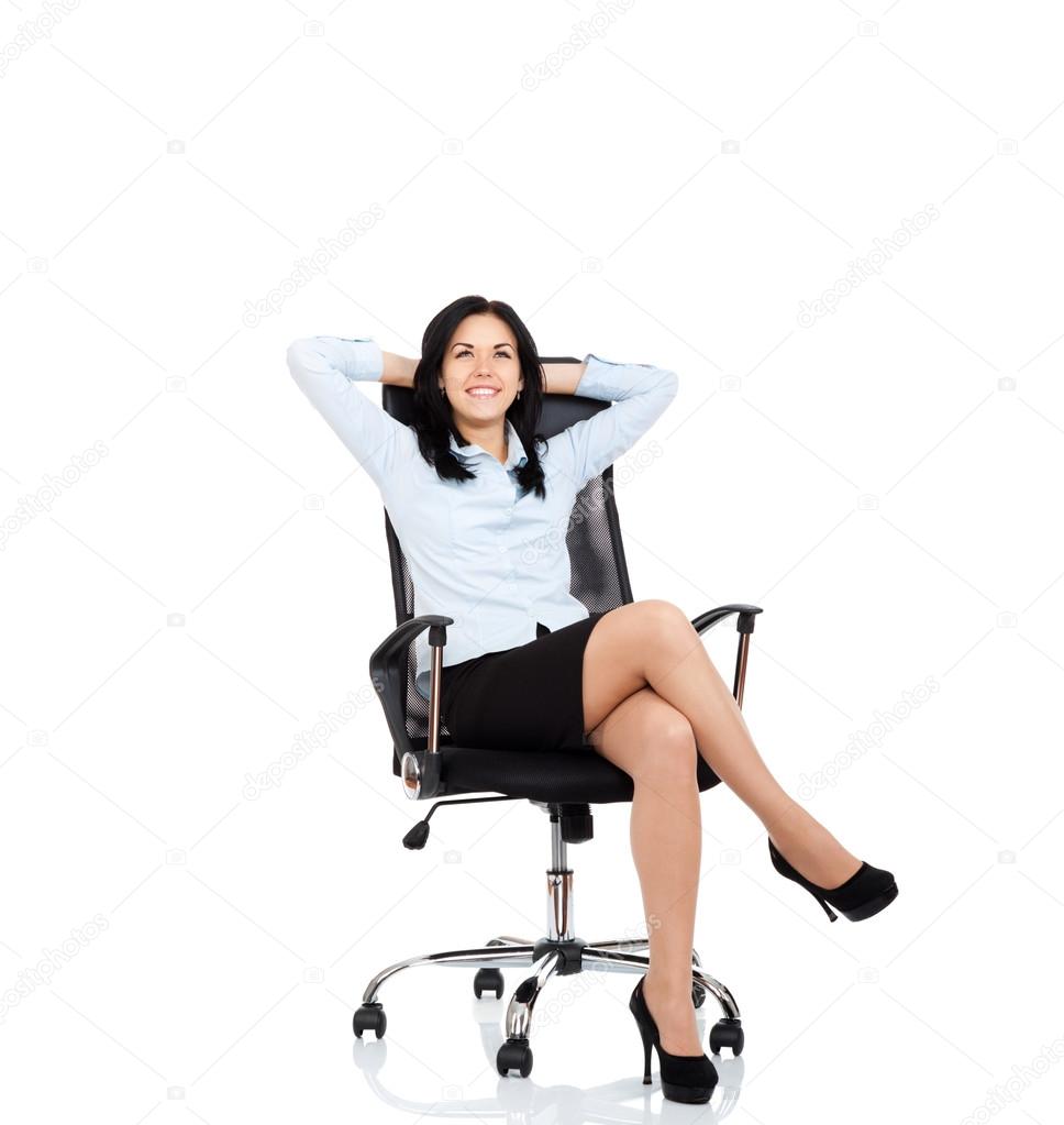 Smiling business woman sitting in chair Stock Photo by ©mast3r 31732615