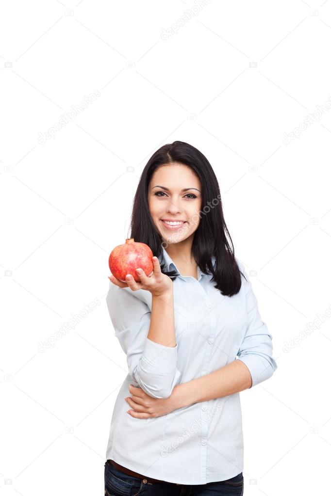 Woman hold red raw pomegranate