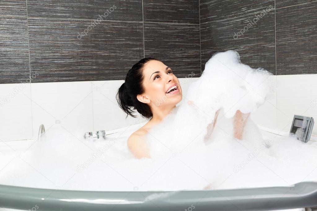 Beautiful woman relaxing in bath