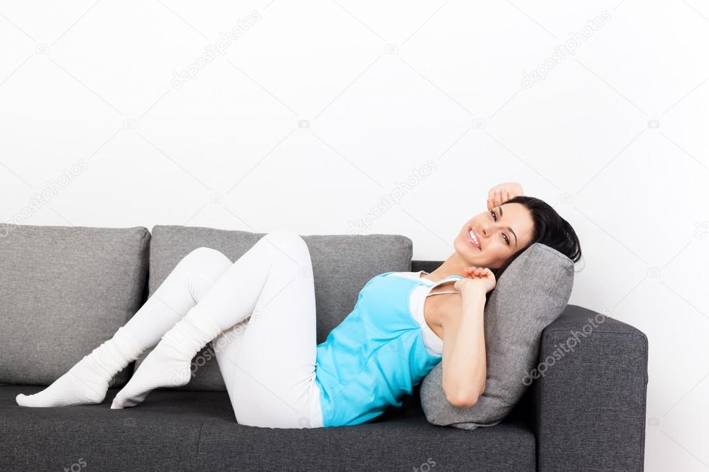 Young woman relaxing on sofa home indoors