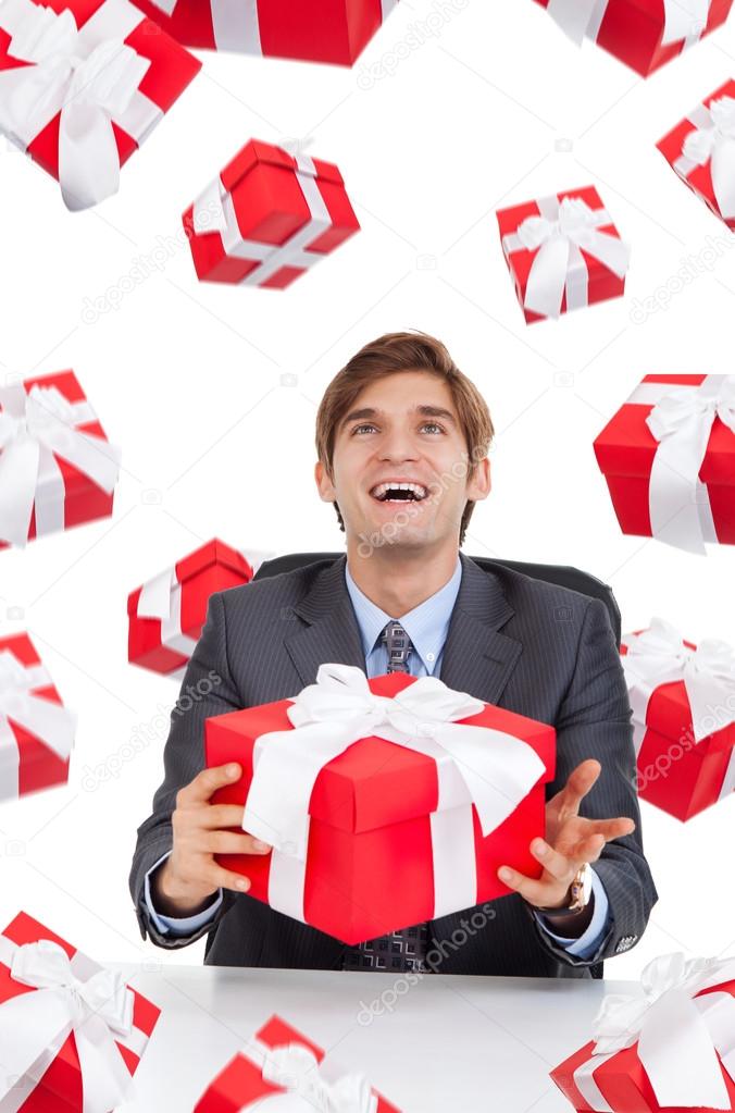 Business man hold red gift box sitting at the desk