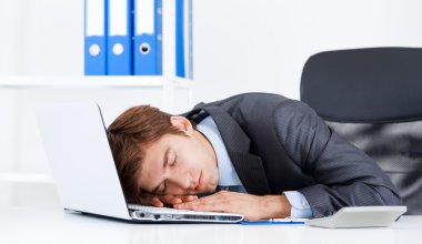 Business man sleeping on his laptop clipart