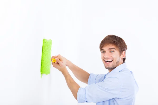 Man paint in green color white wall — Stock Photo, Image