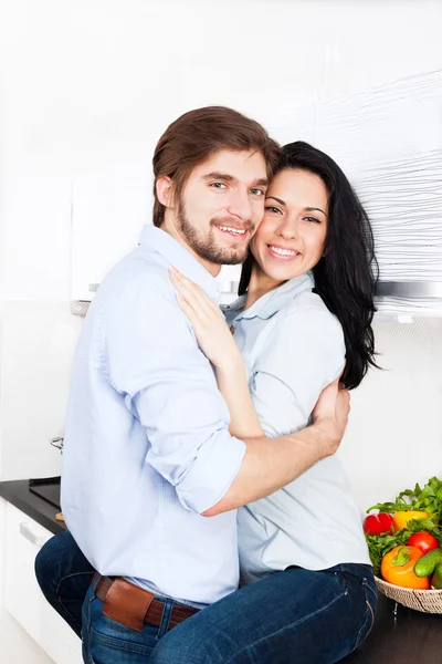 Happy couple cooking at their kitchen — Stock Photo, Image