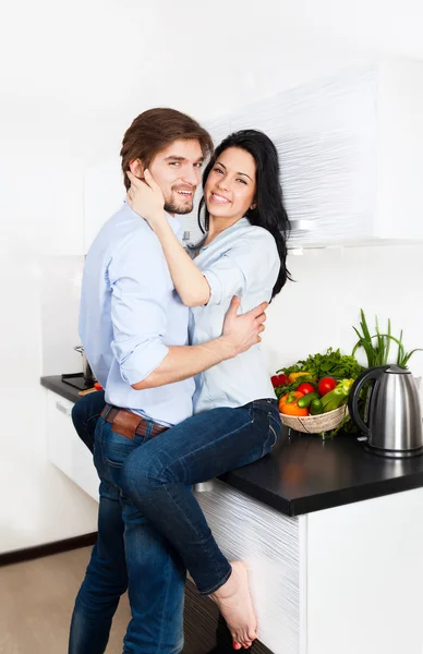 Couple embrace their kitchen home — Stock Photo, Image