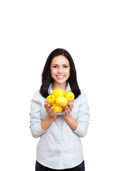 Young woman hold glass bowl full of lemon — Stock Photo, Image