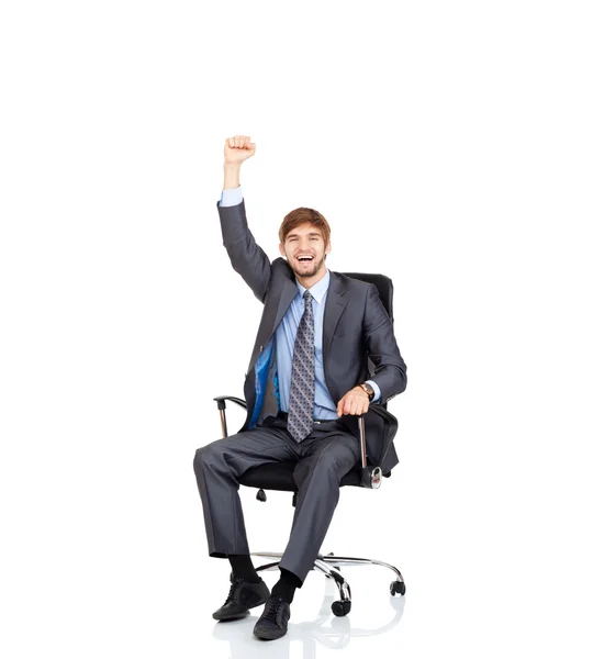 Businessman sitting in chair smile with raised arm — Stock Photo, Image