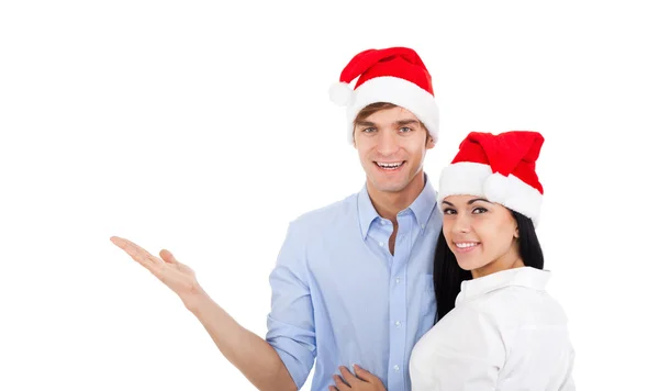 Weihnachtspaar weist auf leeren Kopierraum hin — Stockfoto