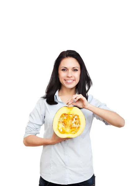 Woman hold raw pumpkin cut in half slice — Stock Photo, Image