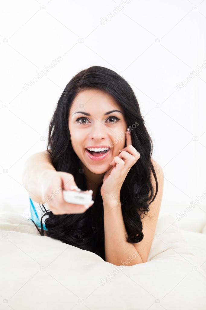 Woman watching tv and hold remote control