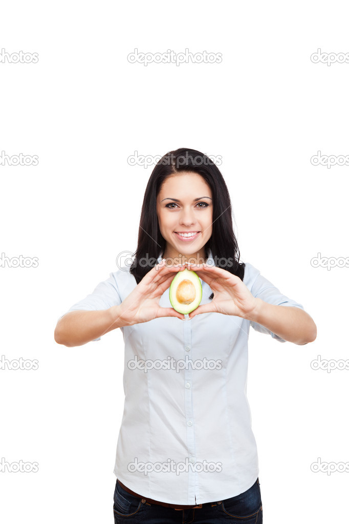 Young woman hold green fresh raw avocado
