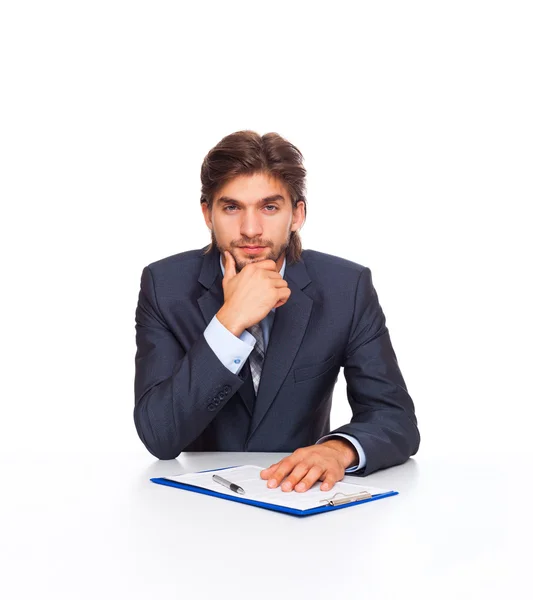 Businessman thinking with clipboard — Stock Photo, Image