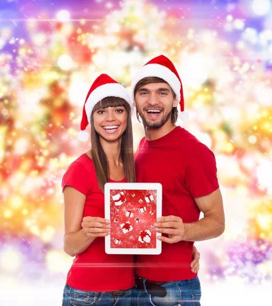 Weihnachtspaar hält Tablet-Pad in der Hand — Stockfoto