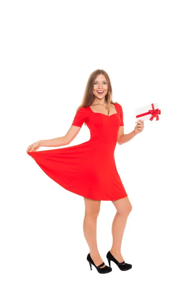 Holiday girl with happy smile holding red gift card — Stock Photo, Image