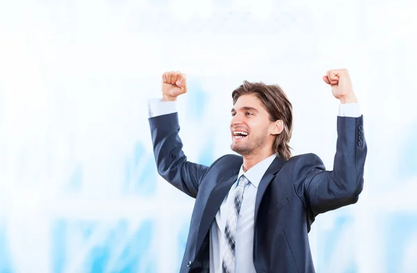 Successful excited business man happy smile hold fists up gesture in bright blue office — Stock Photo, Image