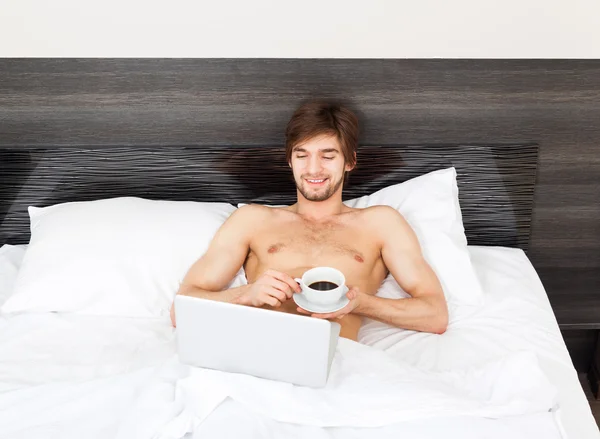 Man on bed — Stock Photo, Image