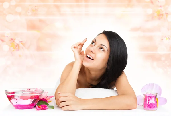 Vrouw in spa salon liggend op een massagetafel — Stockfoto